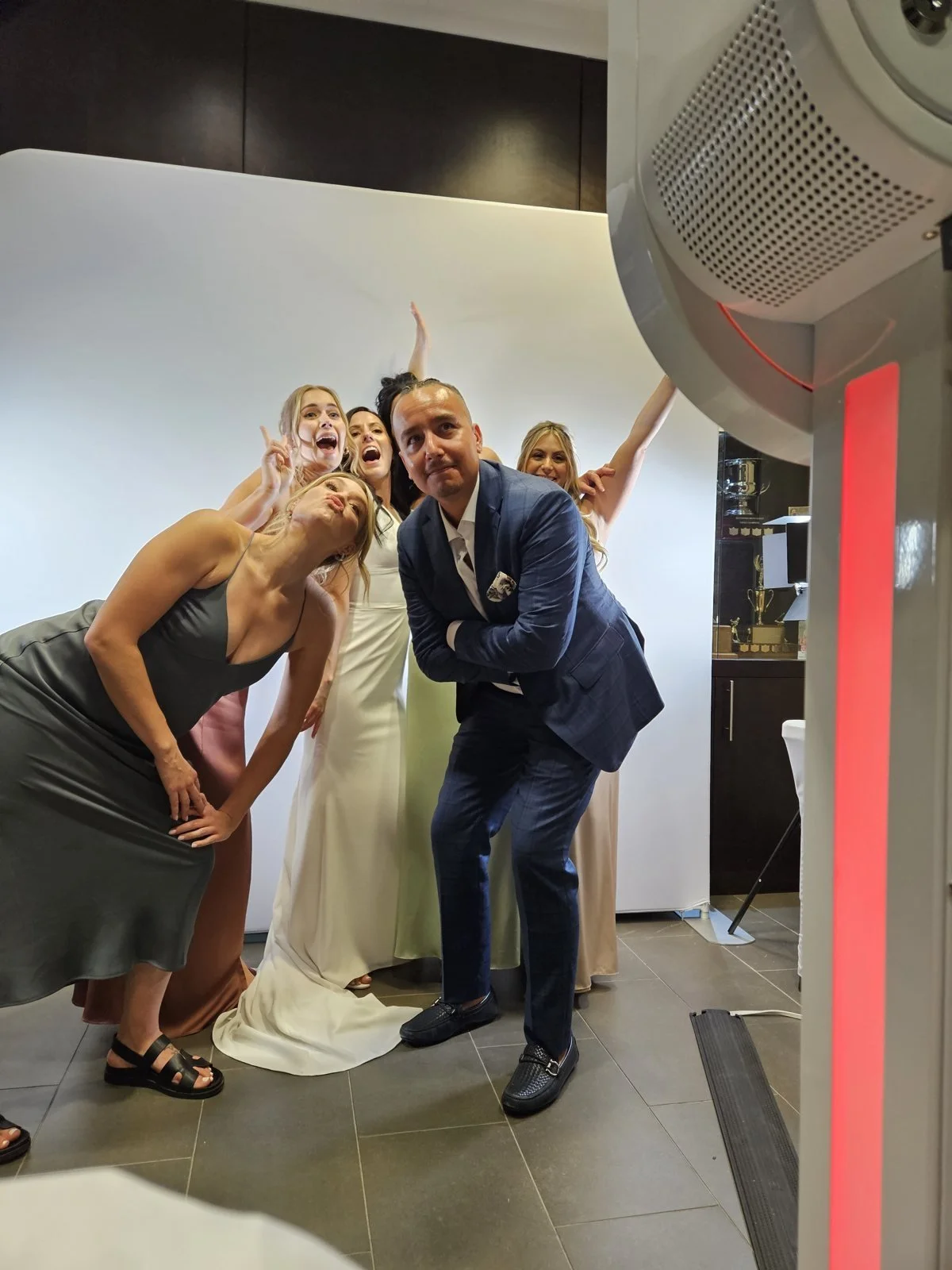 The bride and her friends hamming it up at the photo booth during a Winnipeg wedding reception