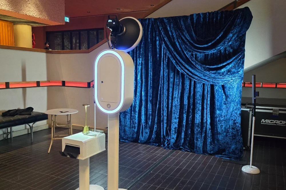 Blue crushed velvet draping set up behind the Aura photo booth