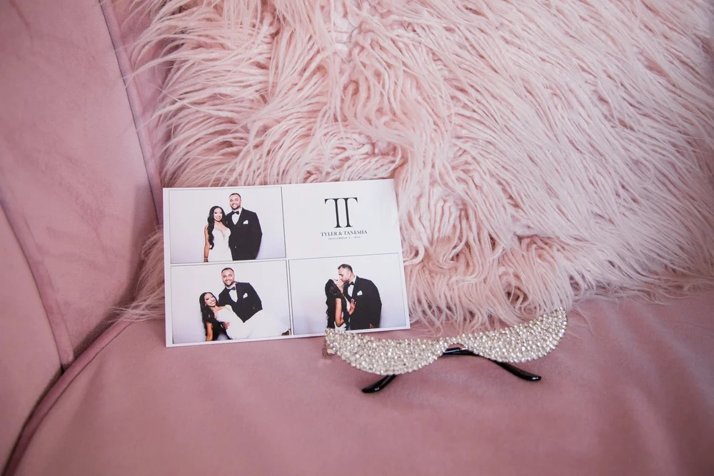 A 4x6 photo booth print with three poses on a pink velvet chair beside rhinestone glasses
