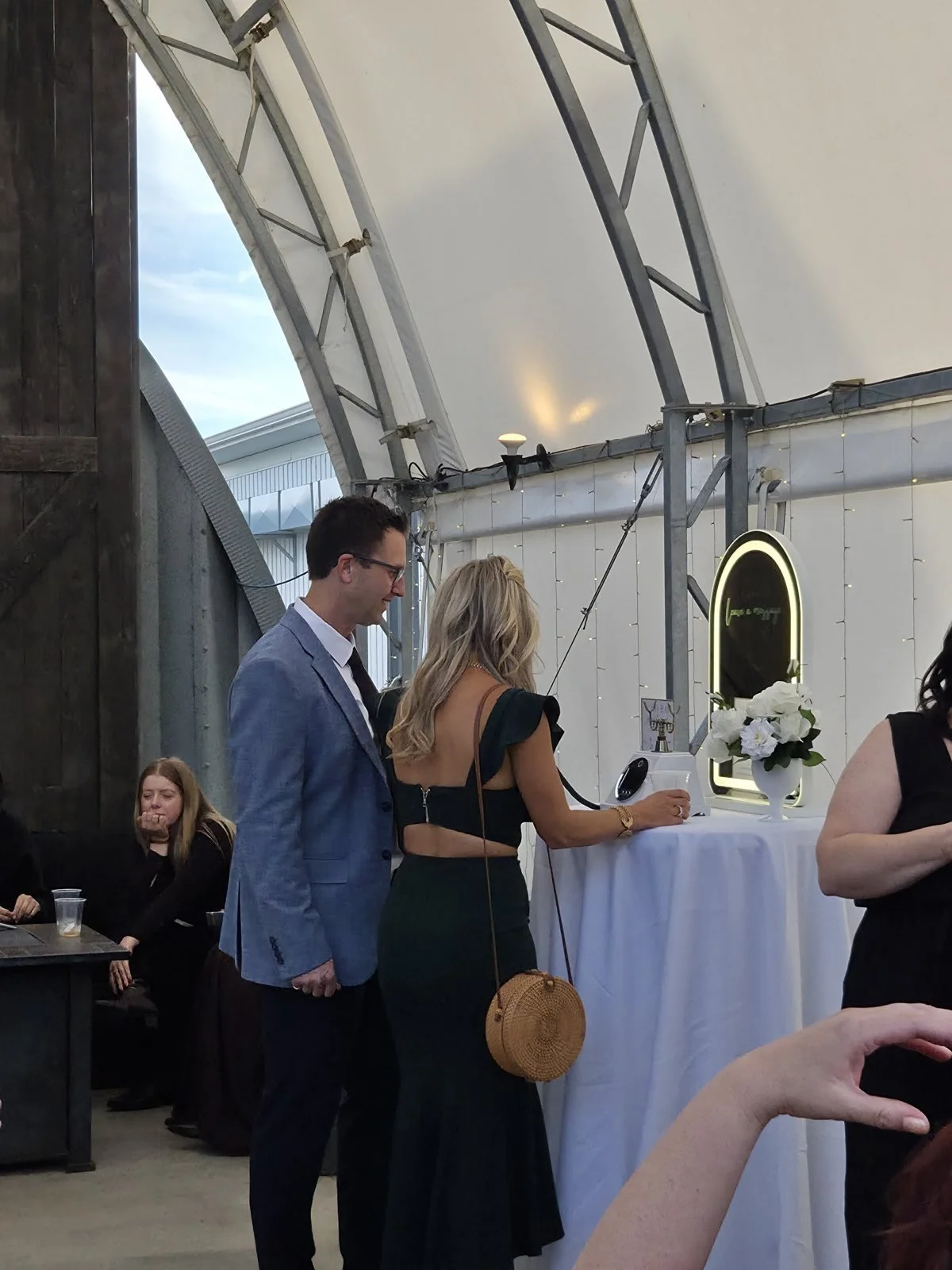 Two guests recording a message on the video guest book at a Winnipeg wedding