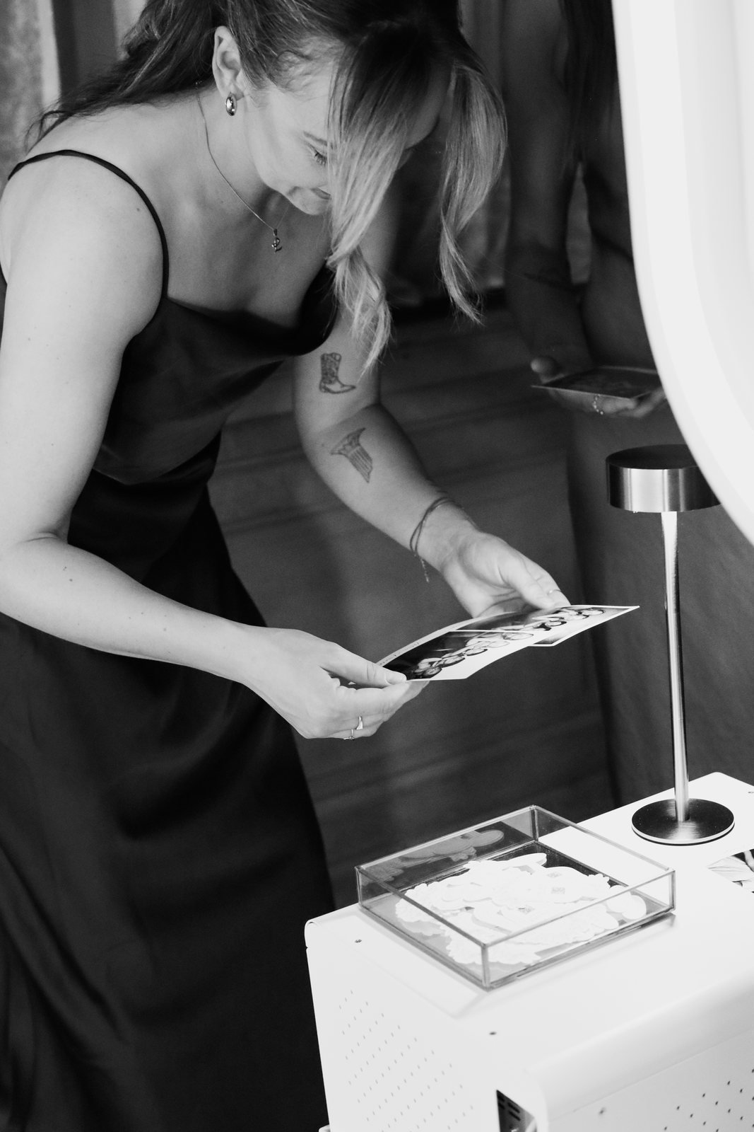 A guest collecting her black and white glam print from the booth