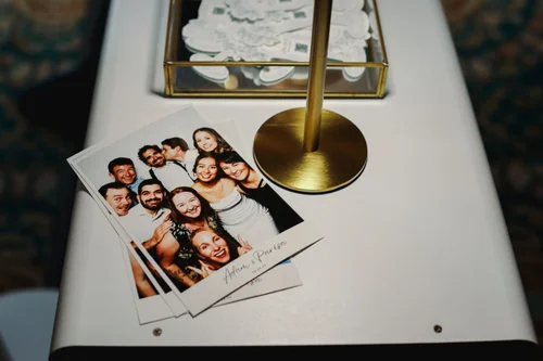 Photo strips coming off the booth printer at a Winnipeg wedding