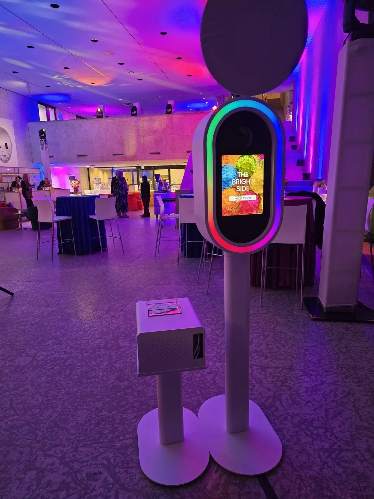 The AI photo booth set up in a ballroom lit purple for a Winnipeg holiday party