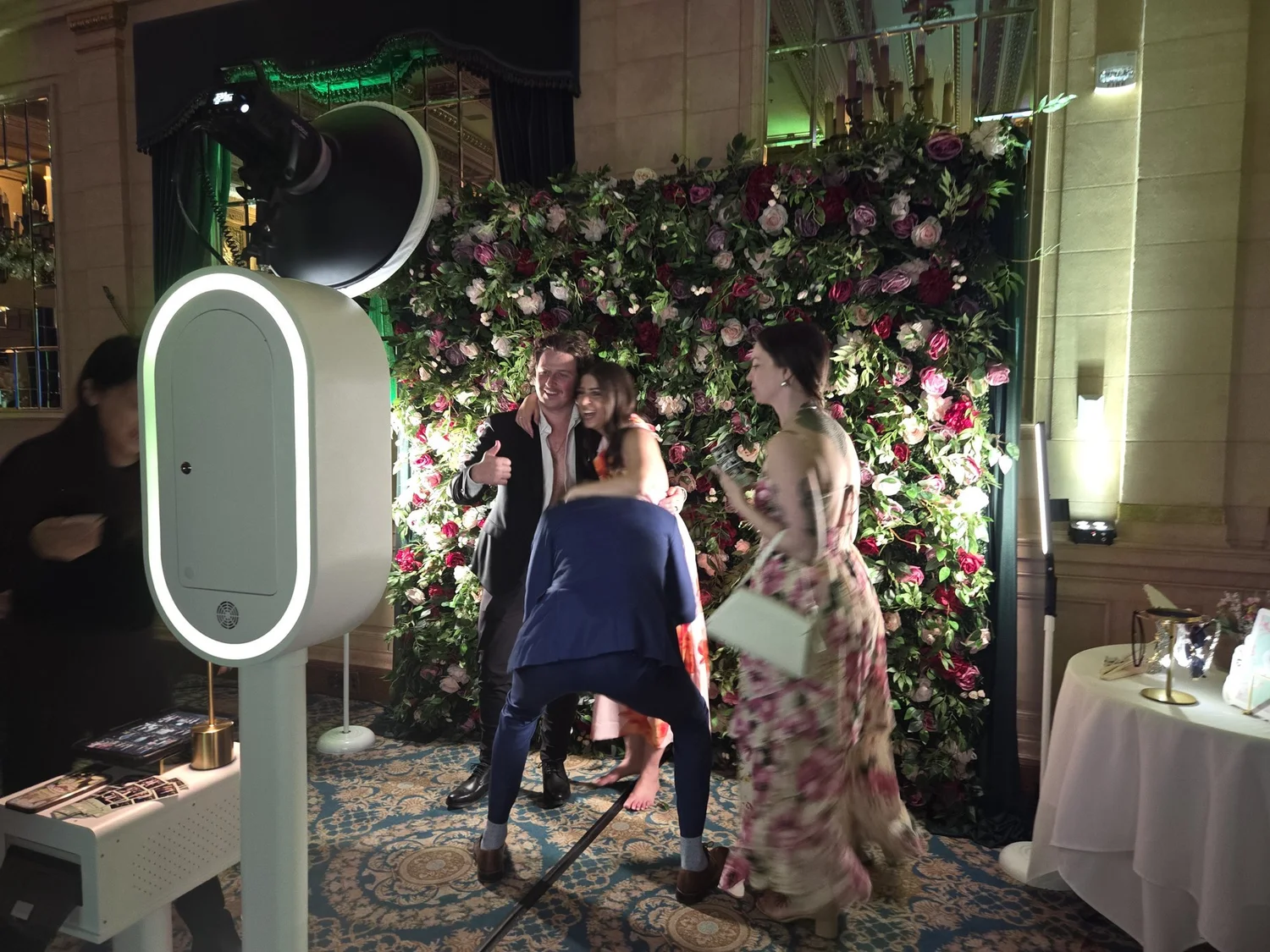 The booth set against a floral wall in the ballroom at the Fort Garry Hotel