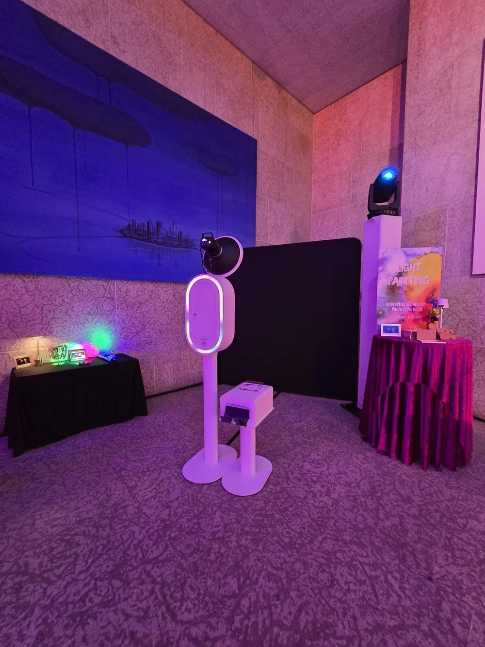 The Nova booth styled with draping and violet uplighting at the Winnipeg Art Gallery