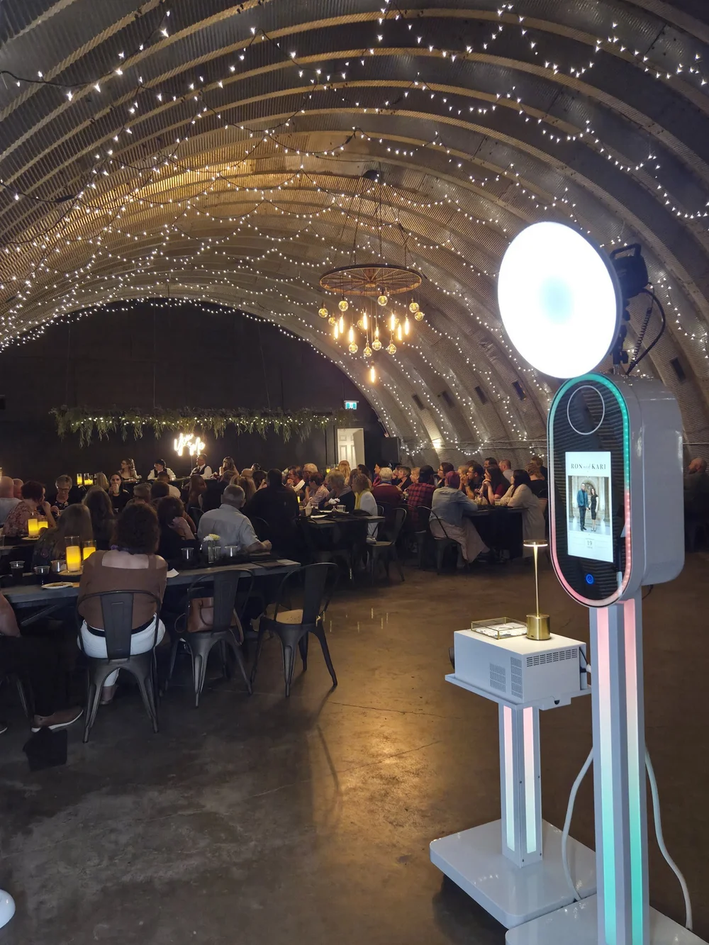 The Aura photo booth under string lights at Prairie Homestead in Altona