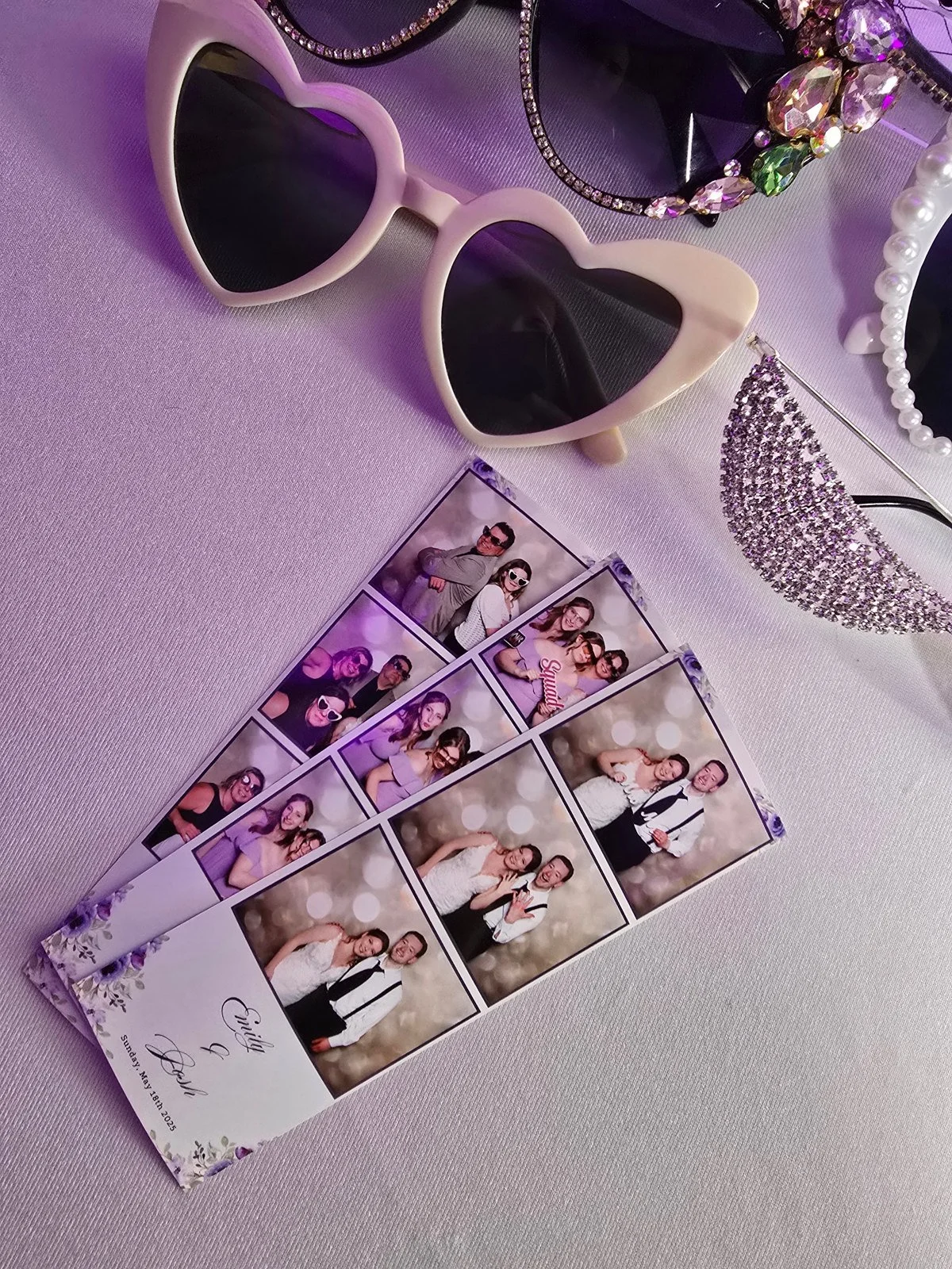 Wedding photo strips with a floral design and the couple's names beside heart shaped sunglasses