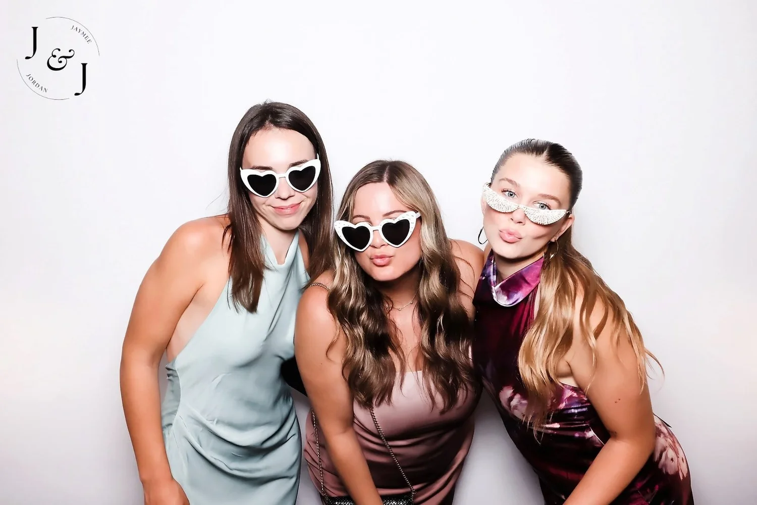 Three wedding guests in heart sunglasses at a Winnipeg wedding, printed in colour by On Que Photo Booth