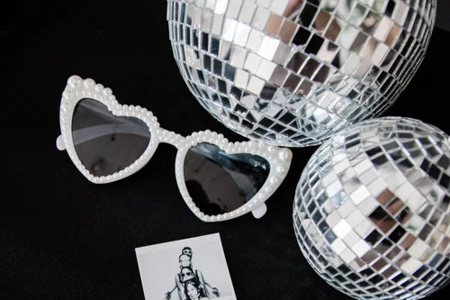 Black and white photo strip with heart glasses and a disco ball