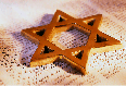 Star-shaped cookie cutter on a lace fabric surface.