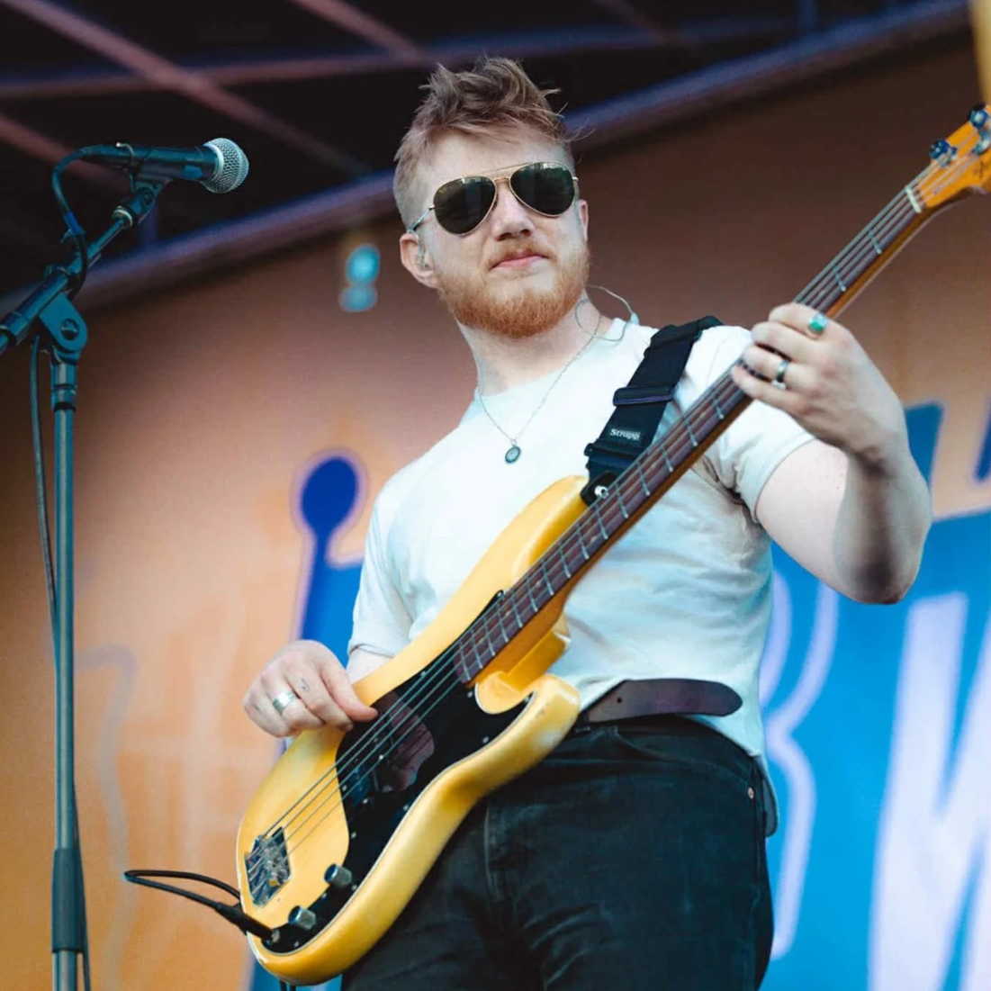 John MacNeil on stage playing electric bass