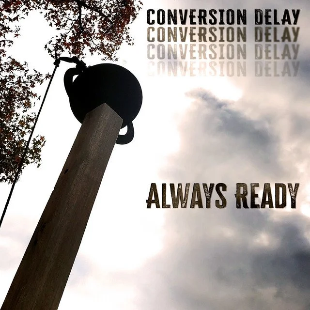Silhouette of a swing hanging from a tall wooden pole with a kettle-style bell attached to the top, against a cloudy sky with trees in the background. The text 'CONVERSION DELAY' is repeated and reflected in the sky, with 'ALWAYS READY' written below