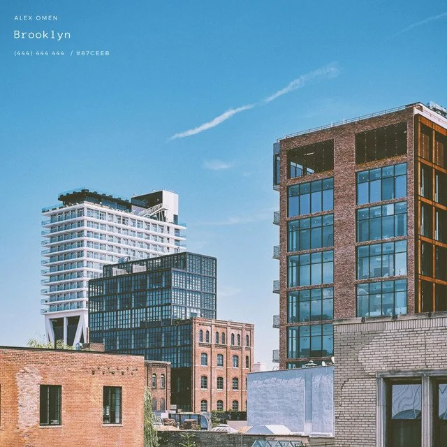 Cityscape of Brooklyn with modern and historic buildings under a blue sky.