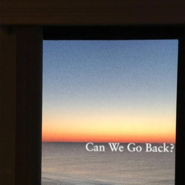 View of a sunset over the ocean seen through a window frame with the text "Can We Go Back?" in the bottom right corner.