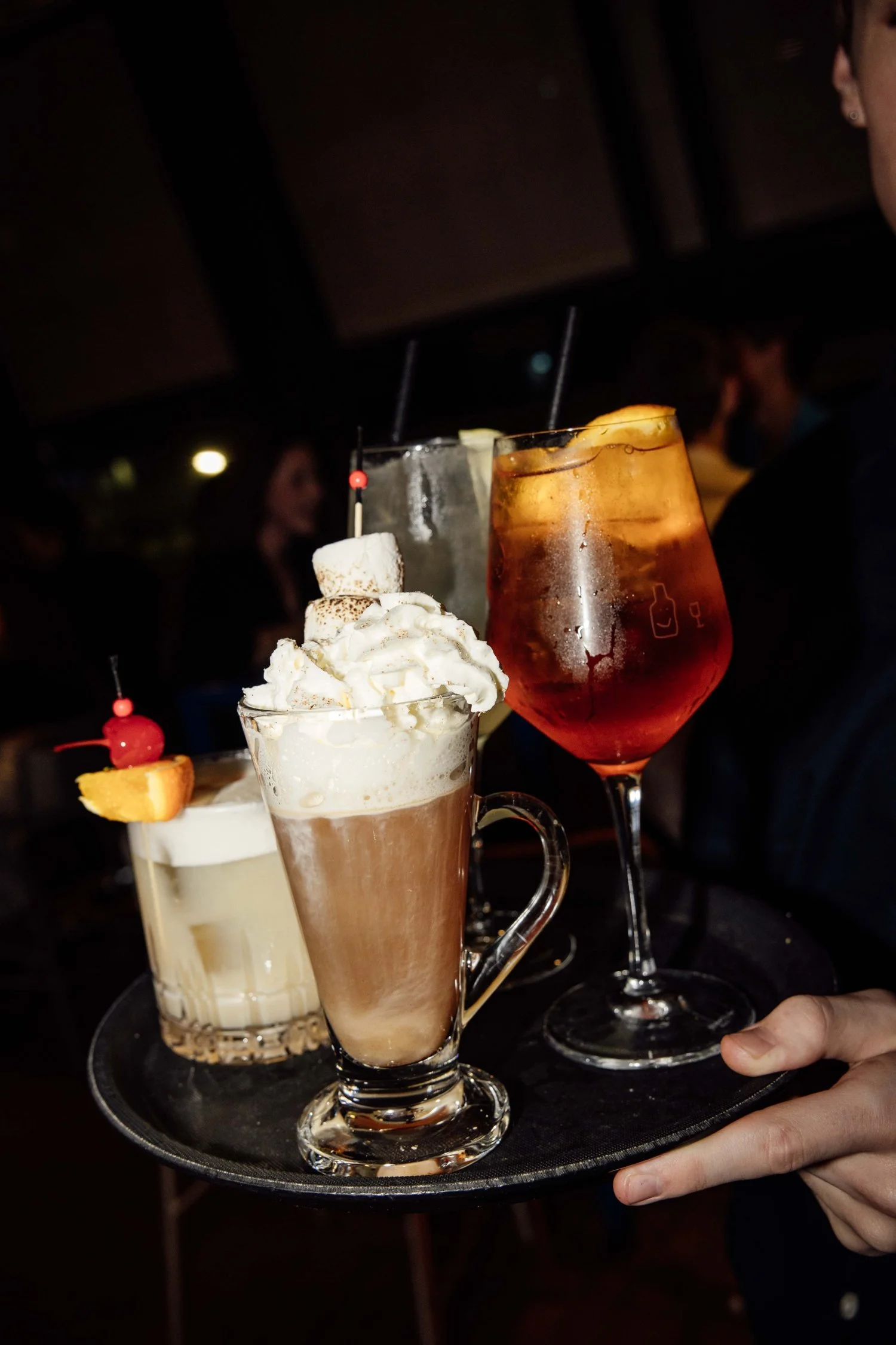 Spritz and cocktails carried on a tray at Good Heavens Rooftop Bar