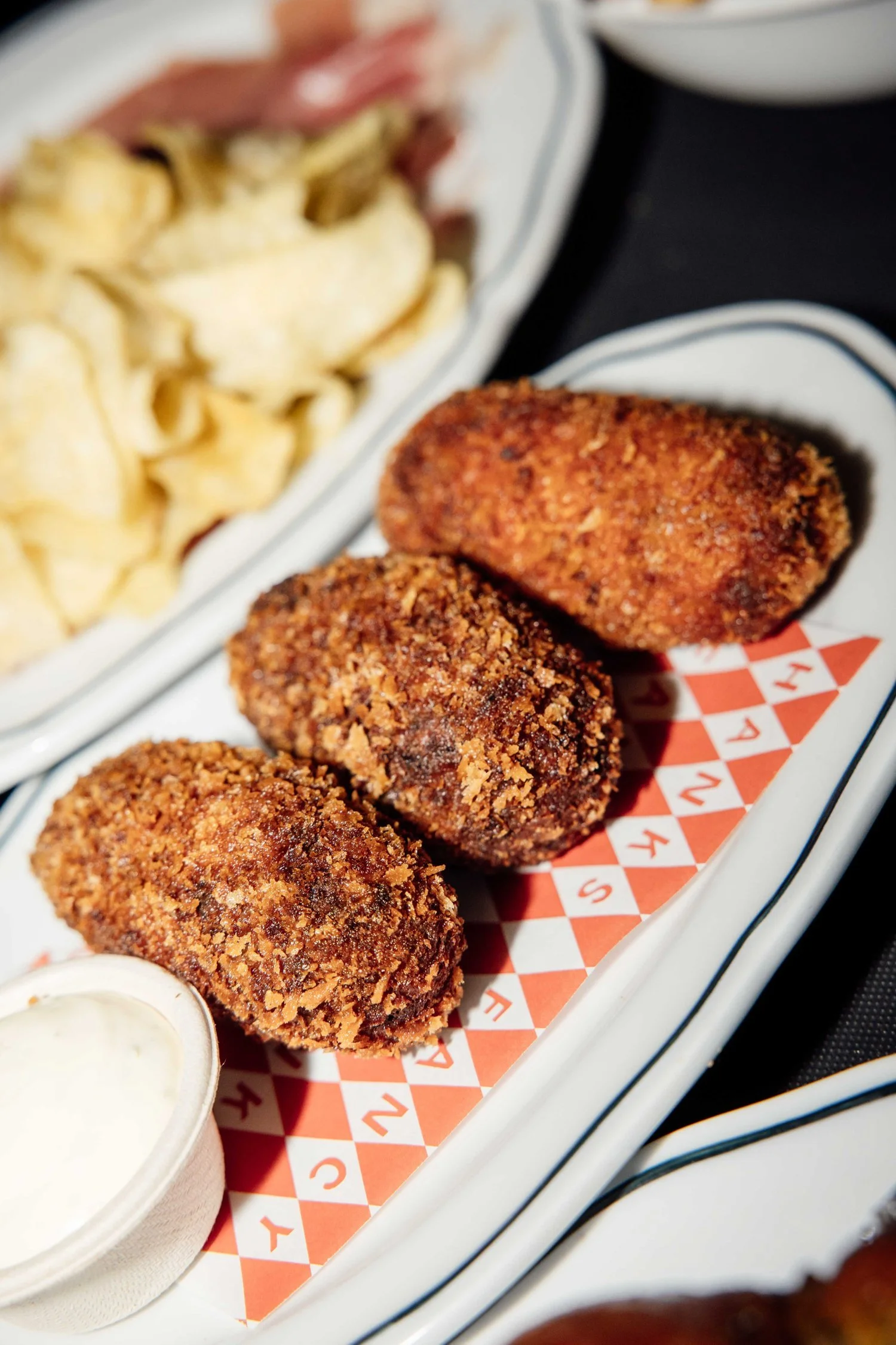 Pork and jalapeno croquettes with chips at Good Heavens Rooftop Bar