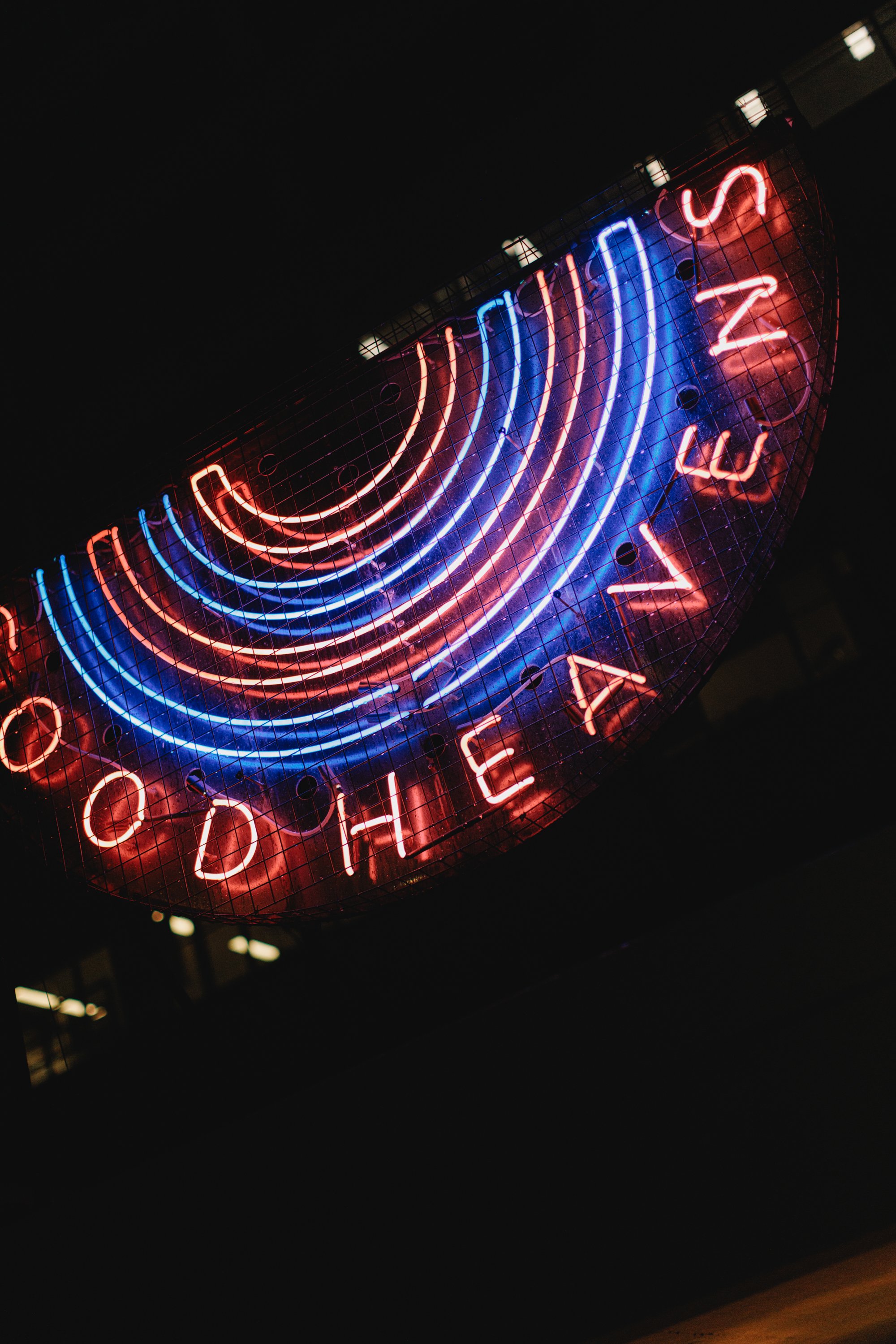 The Good Heavens neon sign glowing red and blue against the night sky