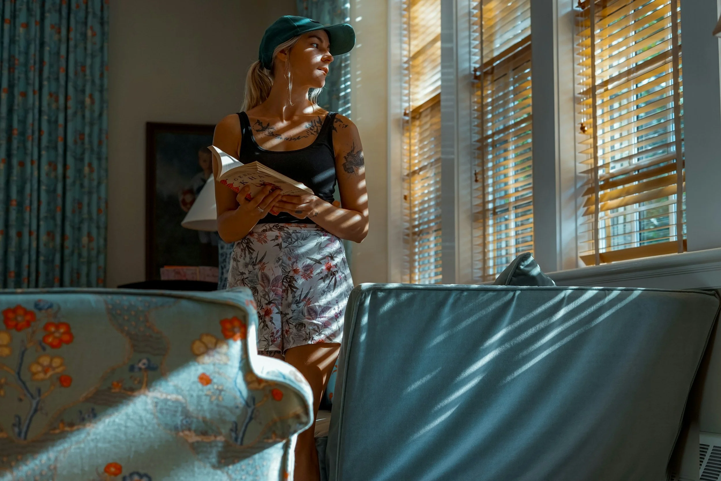 woman resting in living room with book