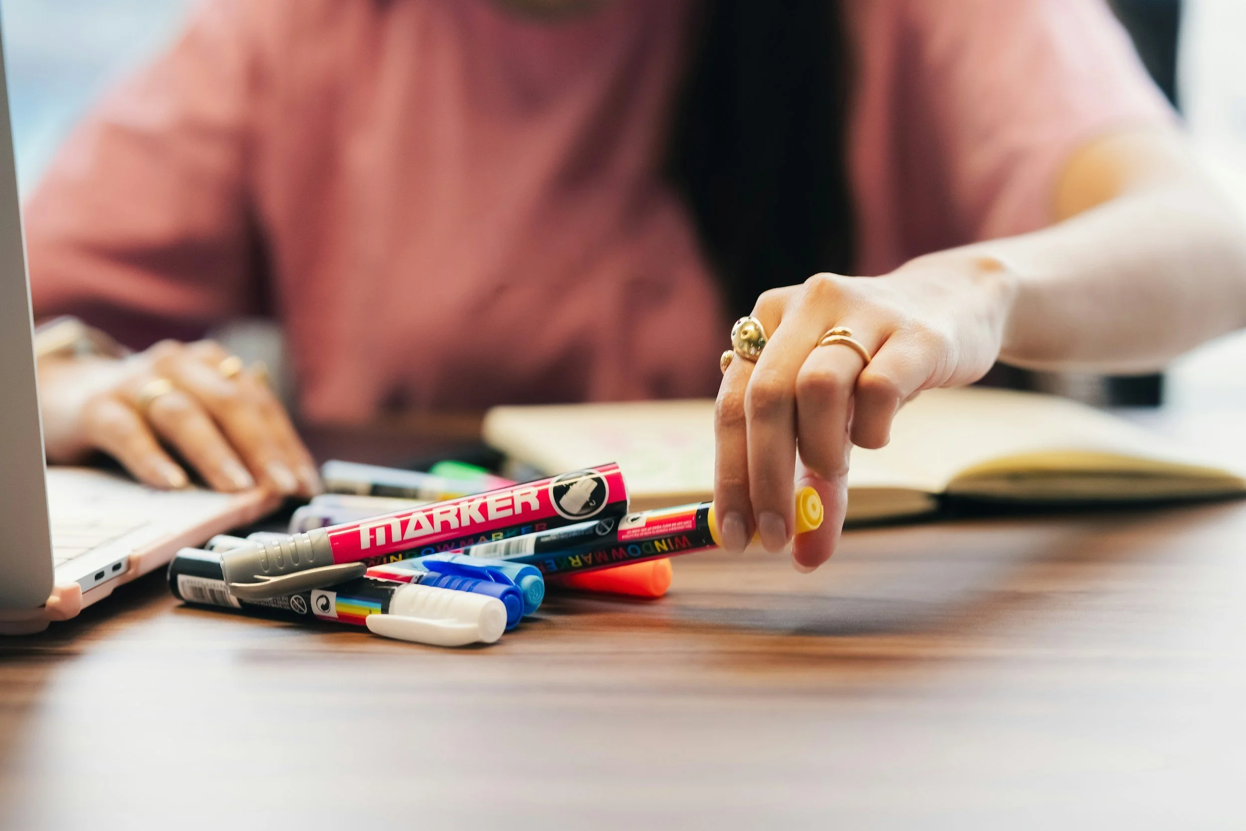 person with markers and planner