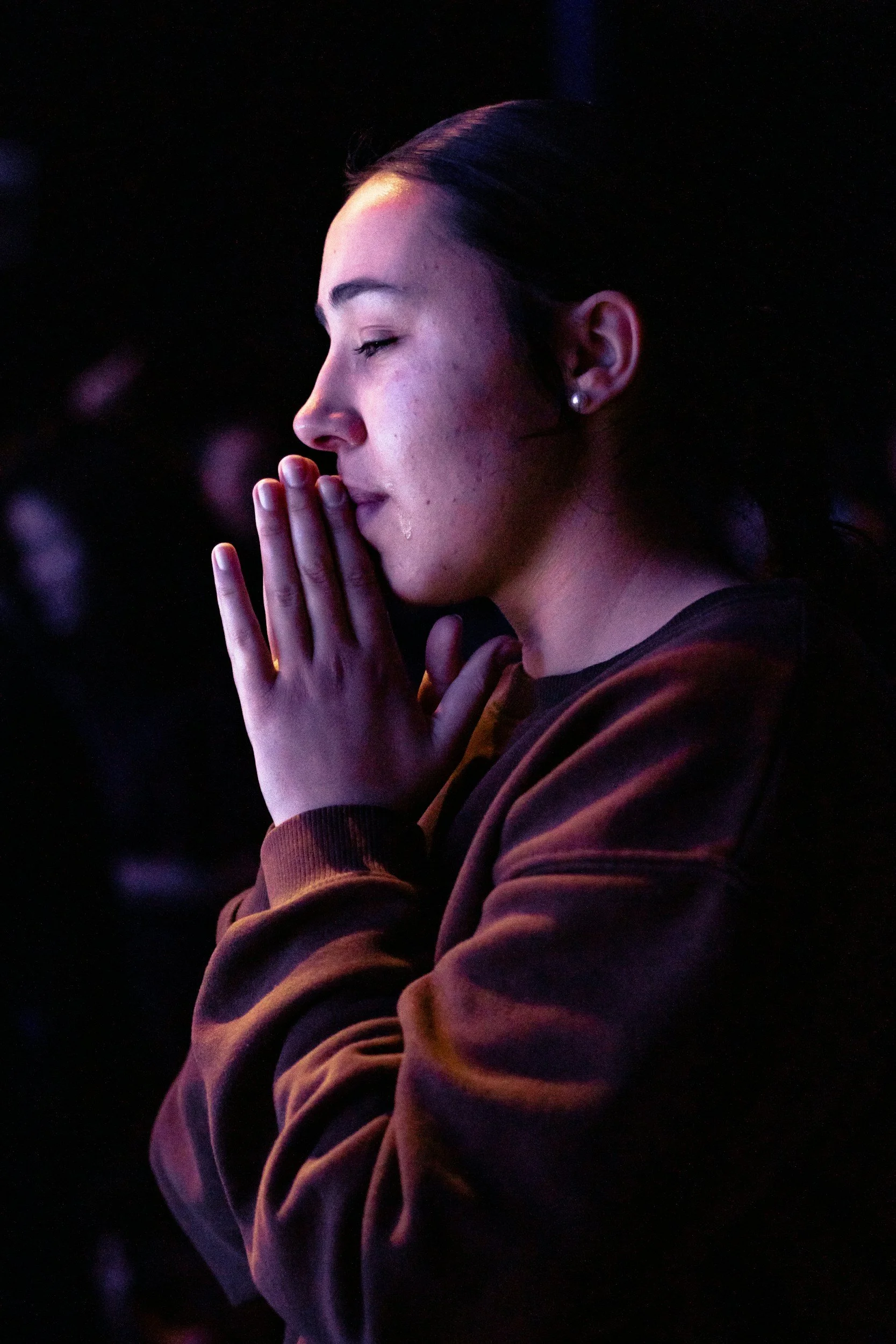 woman tearful with eyes closed