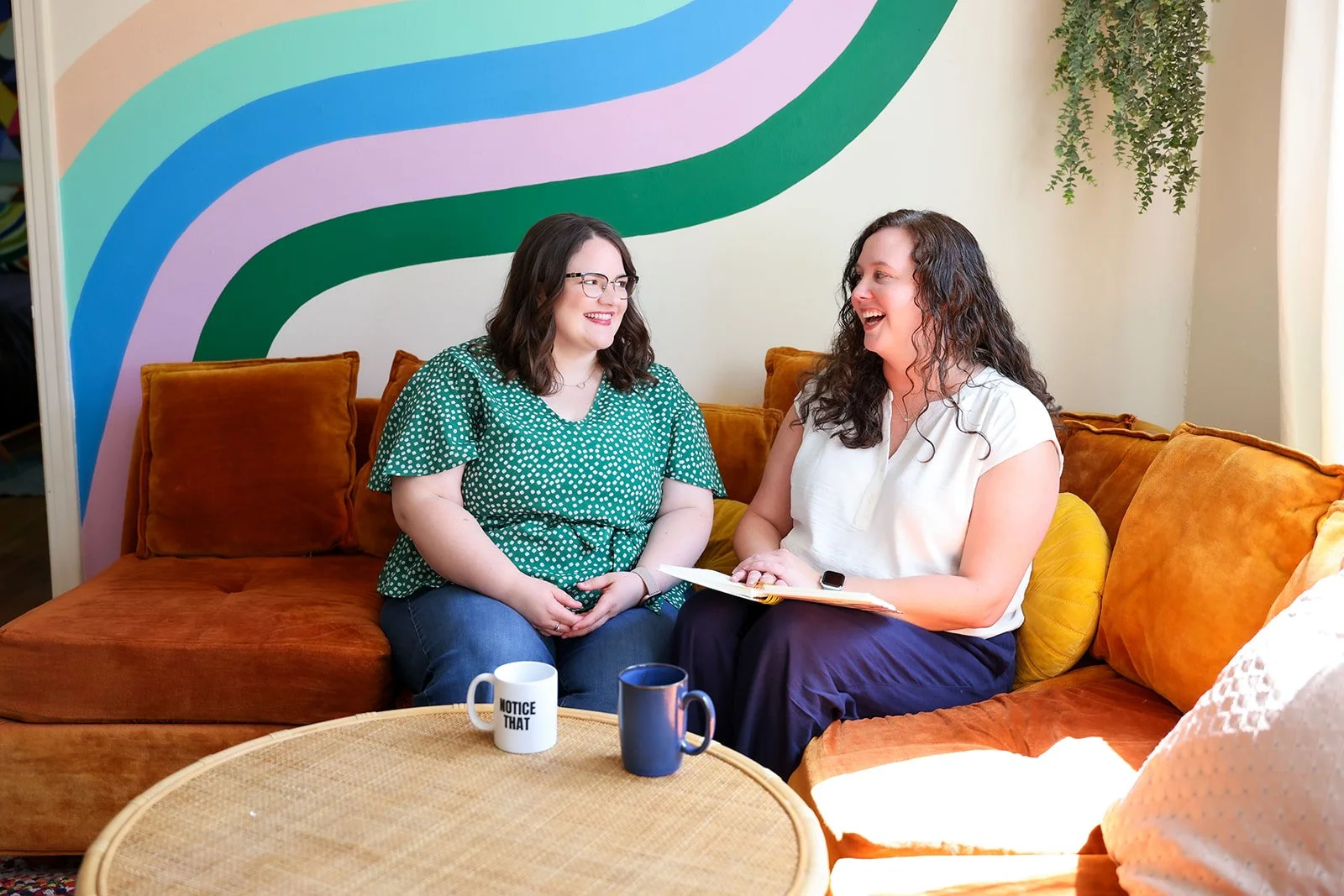 Dallas EMDR therapists laughing on couch together