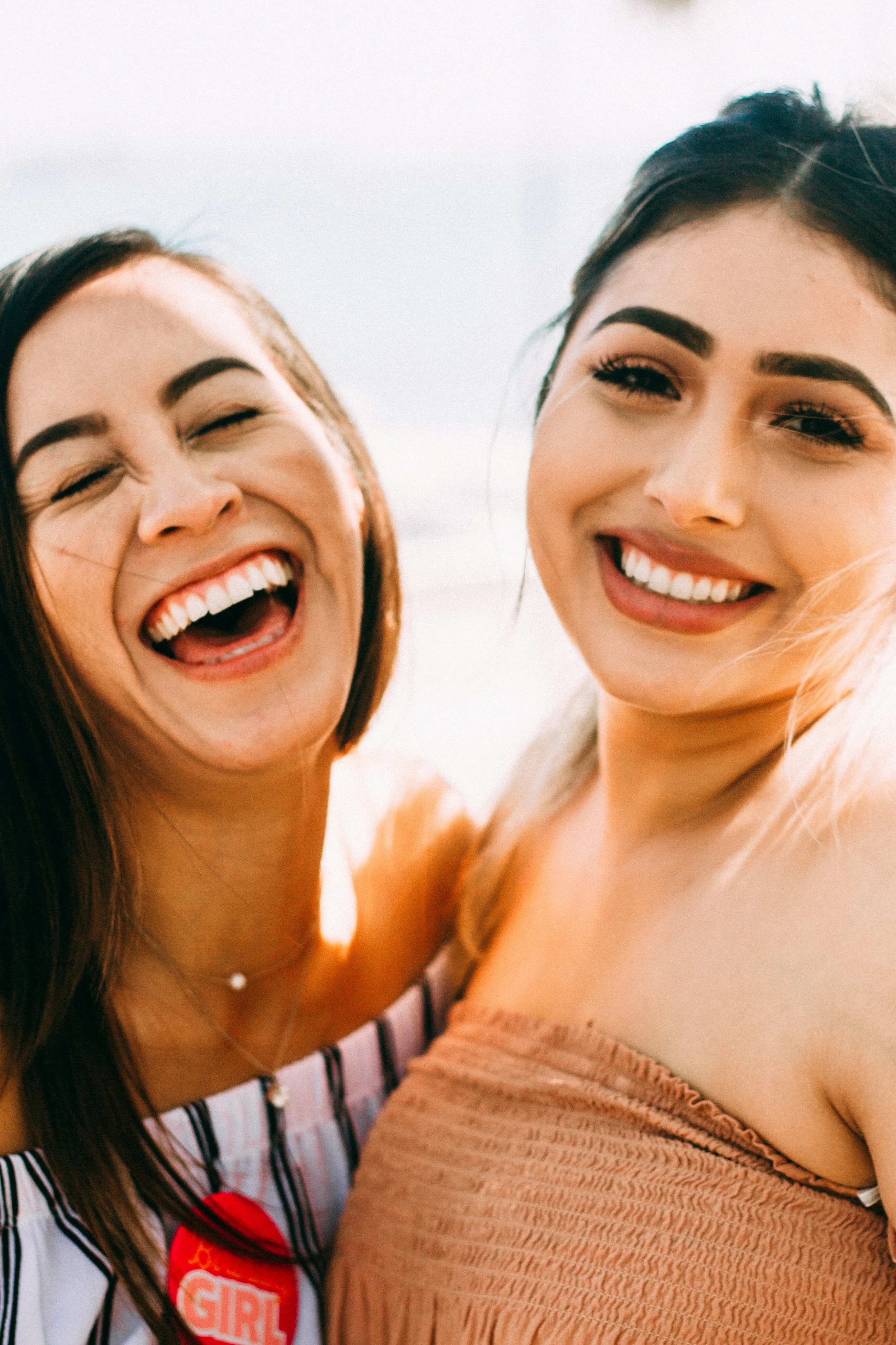 two young women smiling together