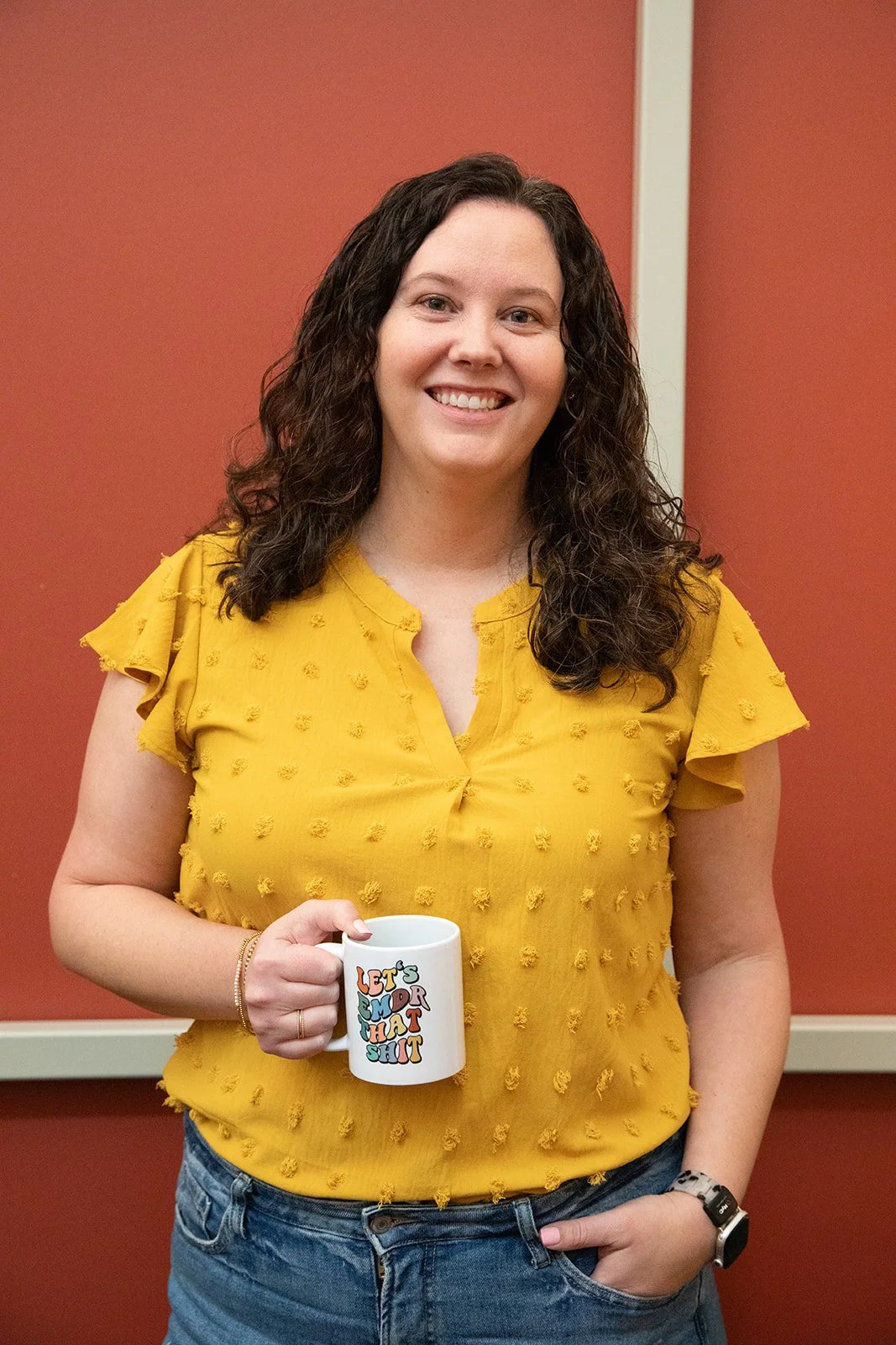 Dallas therapy intensive therapist smiling holding  a coffee mug