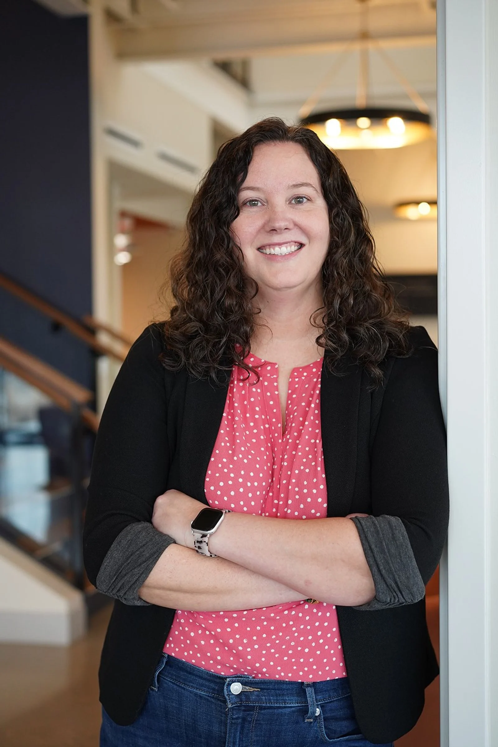 Dallas EMDR therapist leaning on doorframe smiling