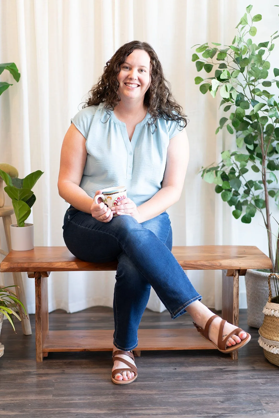 Dallas trauma therapist sitting with coffee mug smiling
