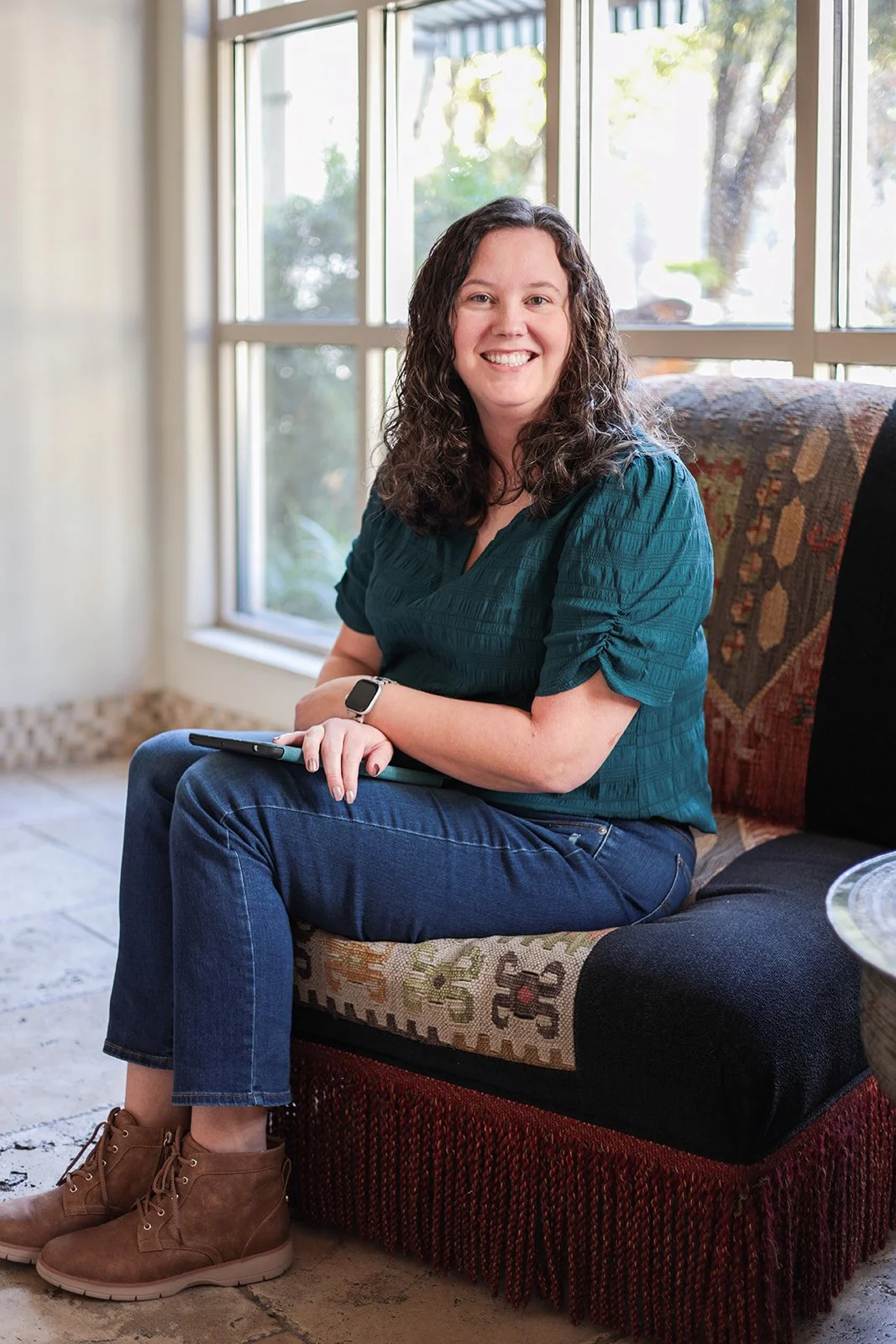 Dallas anxiety therapist sitting in chair smiling