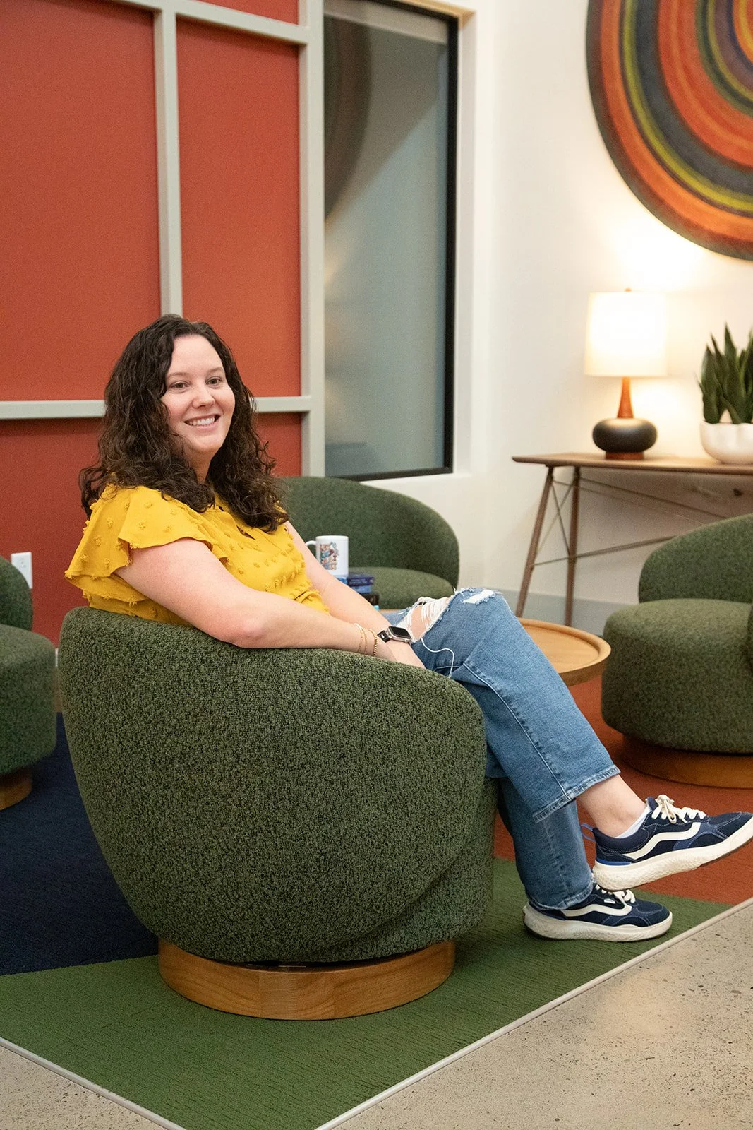 Dallas anxiety therapist sitting smiling in chair