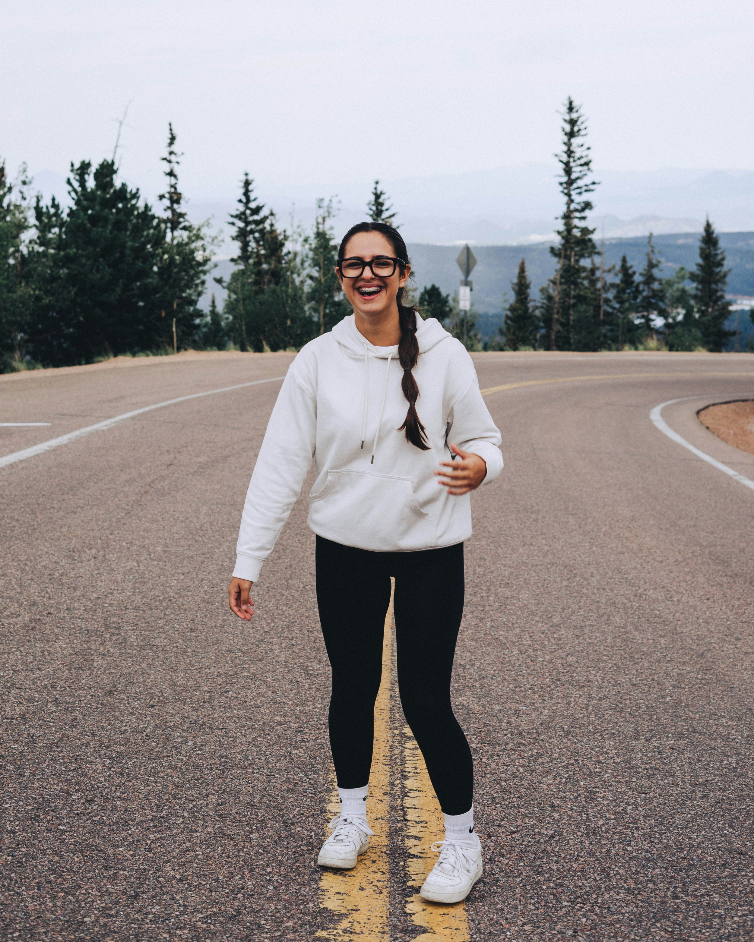 young woman smiling with nature in background