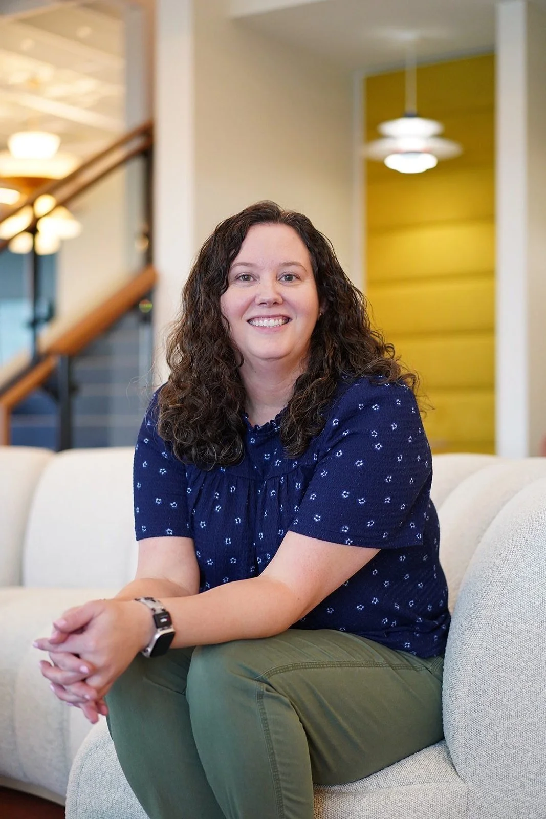 Dallas EMDR intensive therapist sitting on couch smiling
