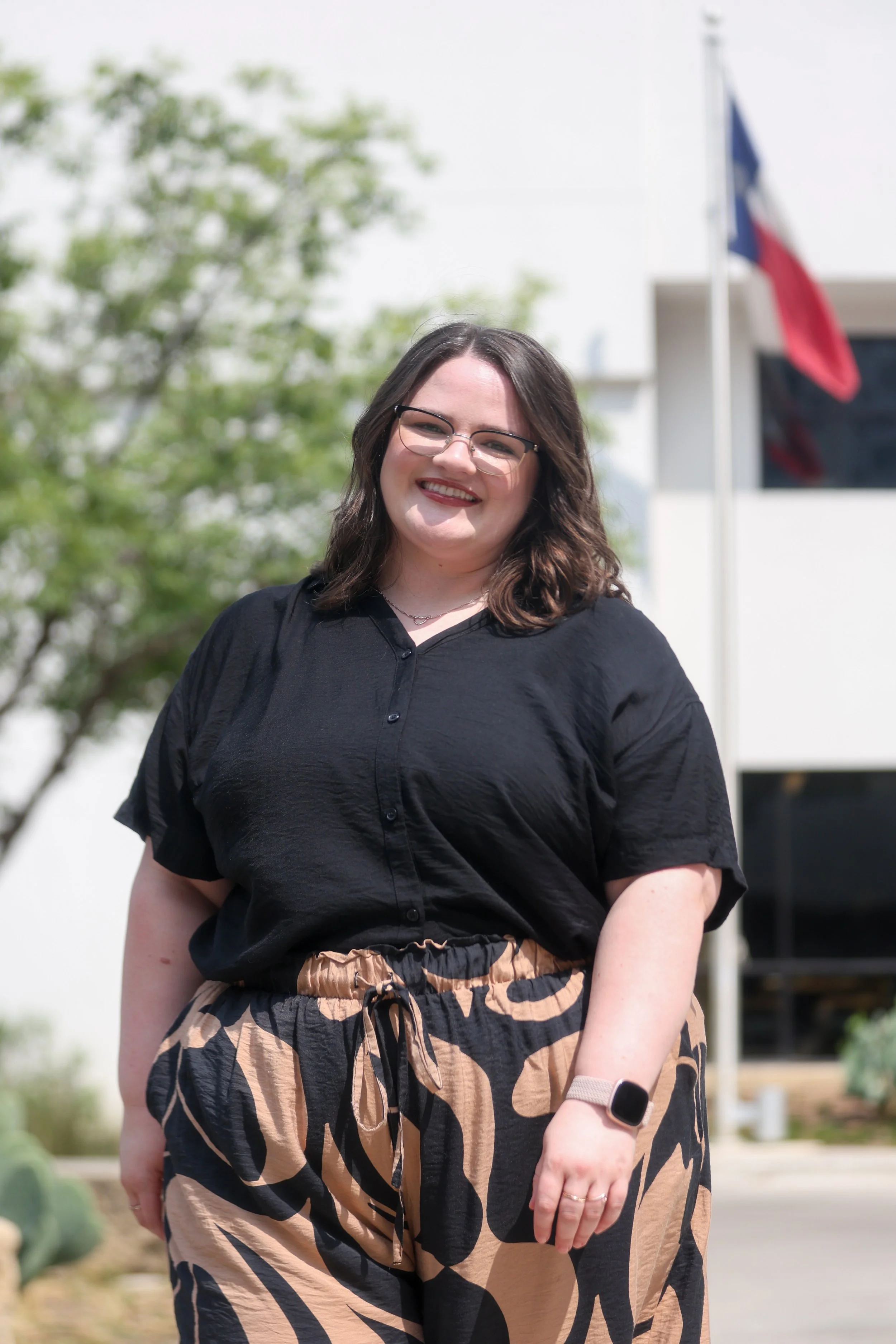 Dallas EMDR therapist outside with Texas flag in background