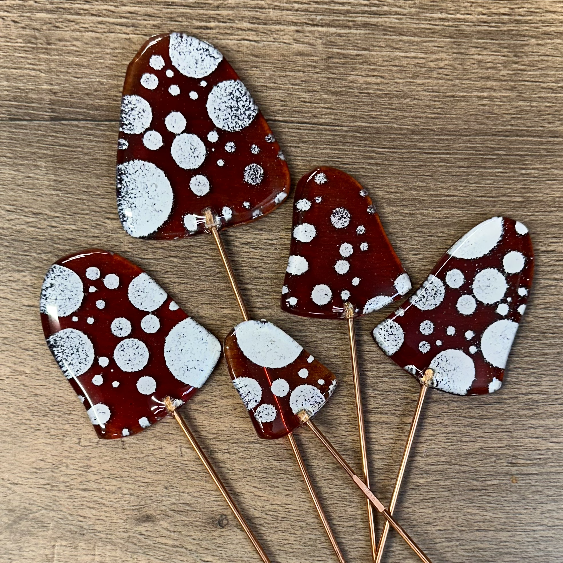 Mushroom Cap Set ($48) Est 1-1.5hrs
Bring some creative color to your plants with this Mushroom Cap Set.  Cut your mushrooms out of clear glass then choose to use glass powders, mosaic glass, paints and bubbles to create your design. Each cap has a c
