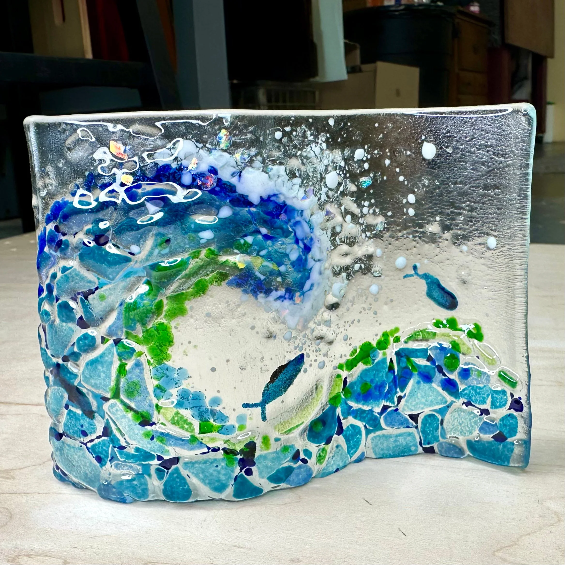 Free Standing Wave ($44) 2hrs
Design a free standing 4x6 wave. Create whatever scene you like. Nip and cut custom mosaic glass, choose to add frit, bubbles, paper glass, paints and sift glass powders to create unique vibrant designs. I have some temp