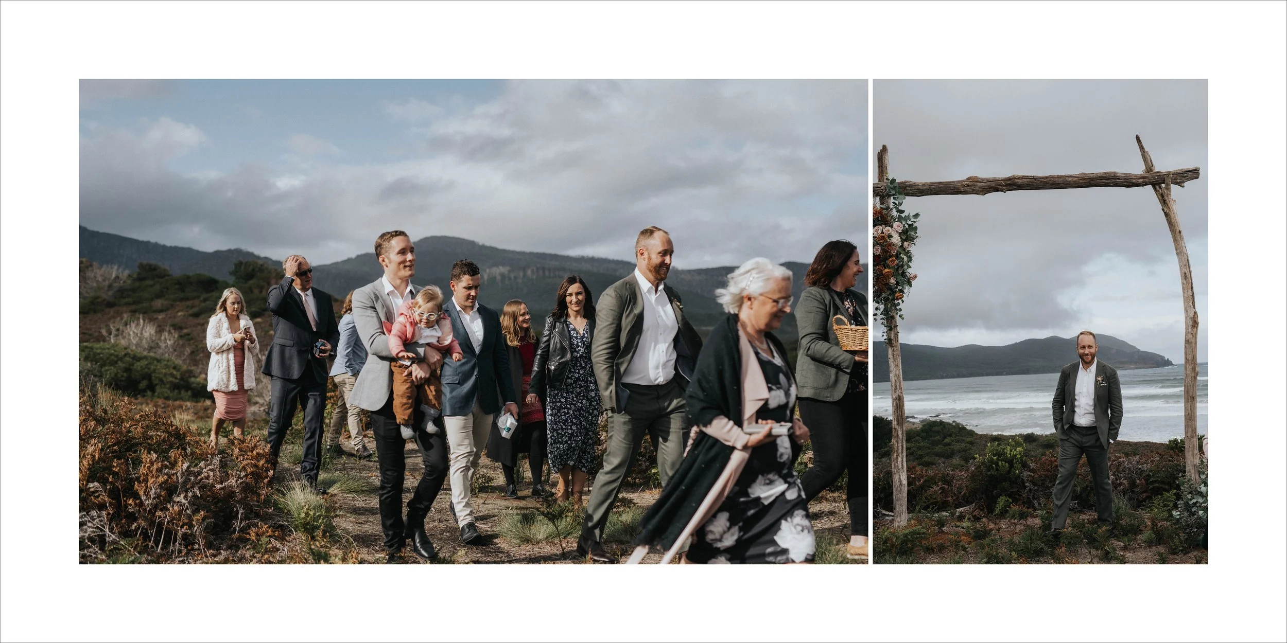 A group of people in formal attire walking along a trail near a coastal area with mountains in the background, during a cloudy day. The right side shows a man standing under a rustic wooden arch decorated with flowers near the ocean.