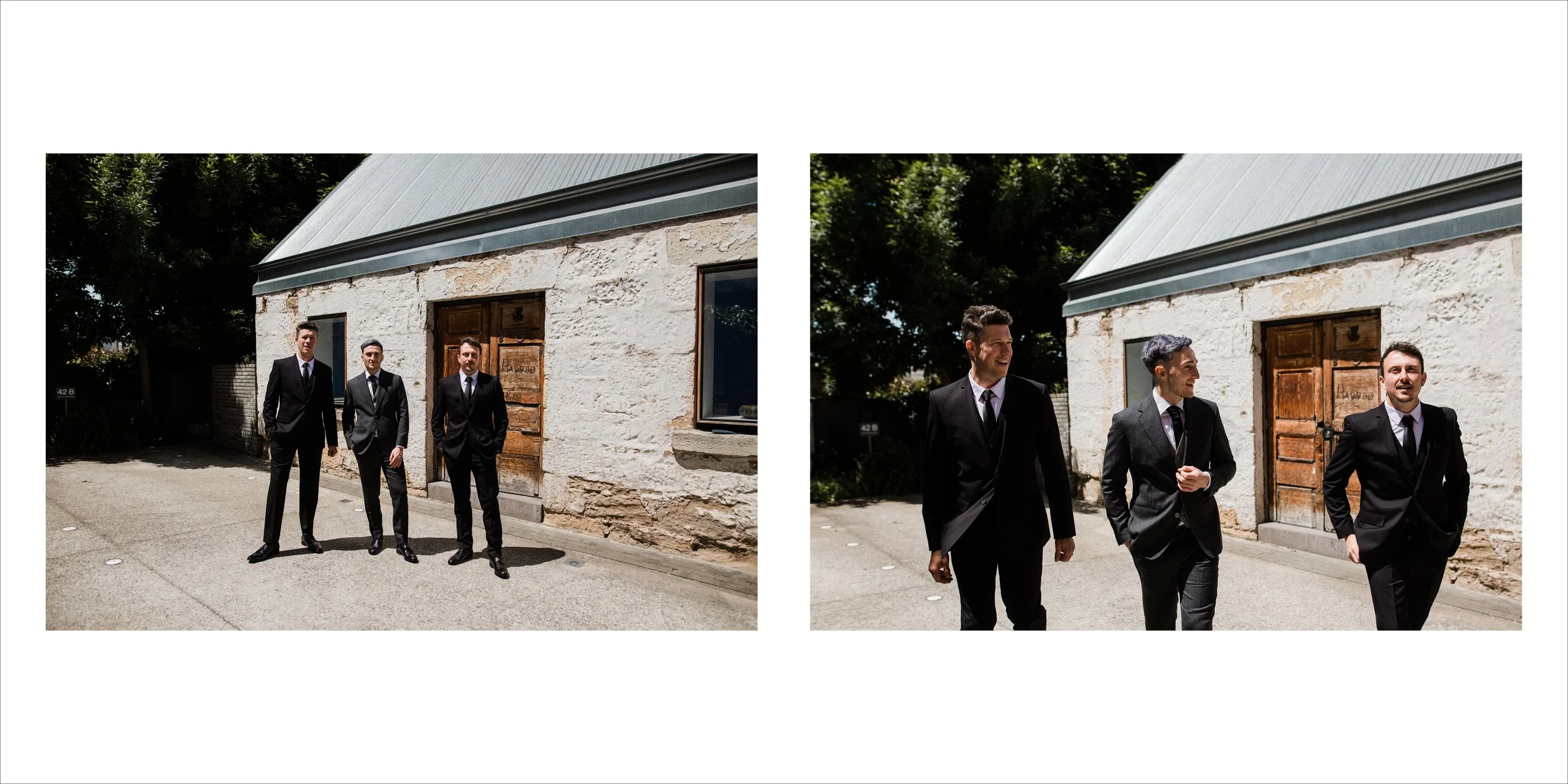 Three men in suits walking on a sidewalk outside a rustic stone building with a metal roof.