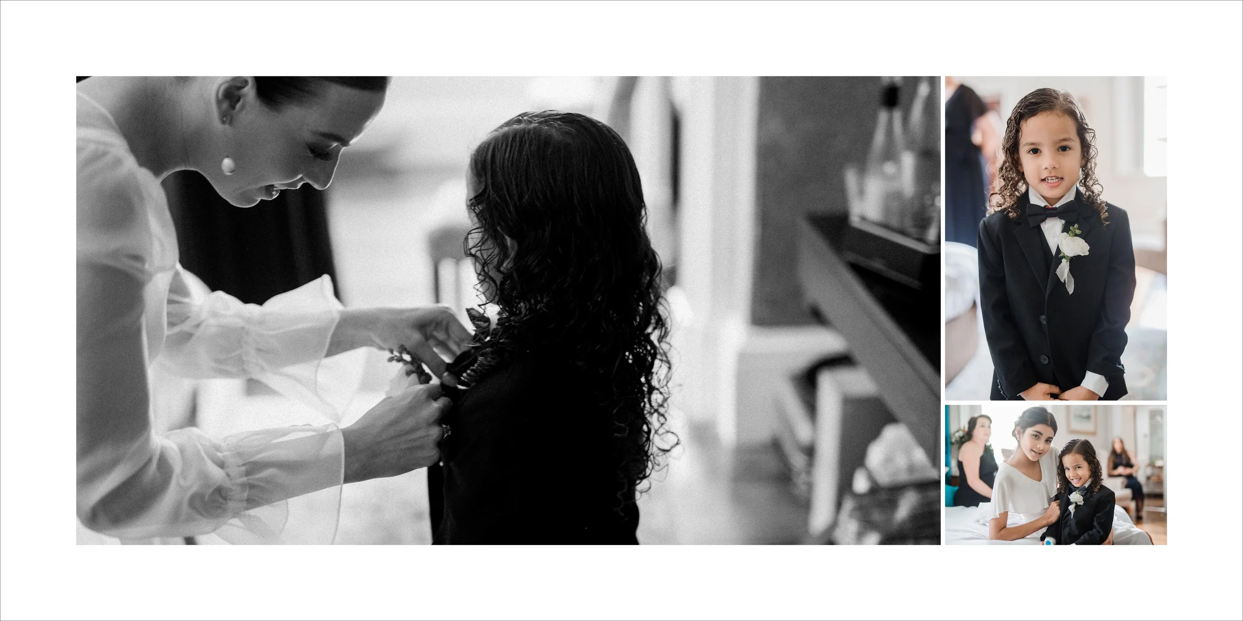 Child in a black tuxedo with flower boutonniere smiling at the camera, two women, one helping the girl get ready, in a bright room with other guests in the background.