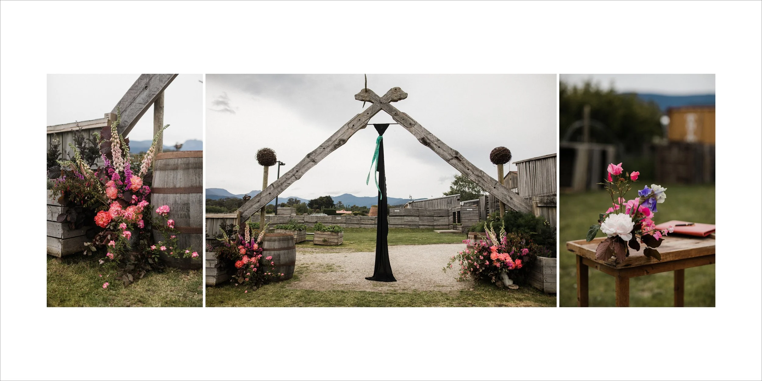 A wedding ceremony setup outdoors with floral decorations, wooden structures, and a table with a floral arrangement.