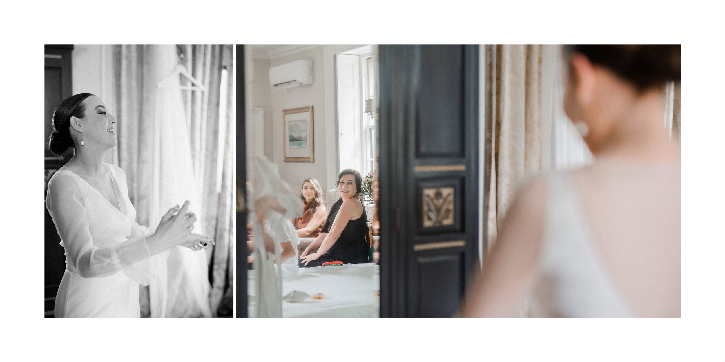 Three women in a well-lit, elegant room with a mirror. One woman is in the foreground, smiling as she looks at her reflection, wearing a white dress. The other two women are in the background, sitting and smiling, observing her.