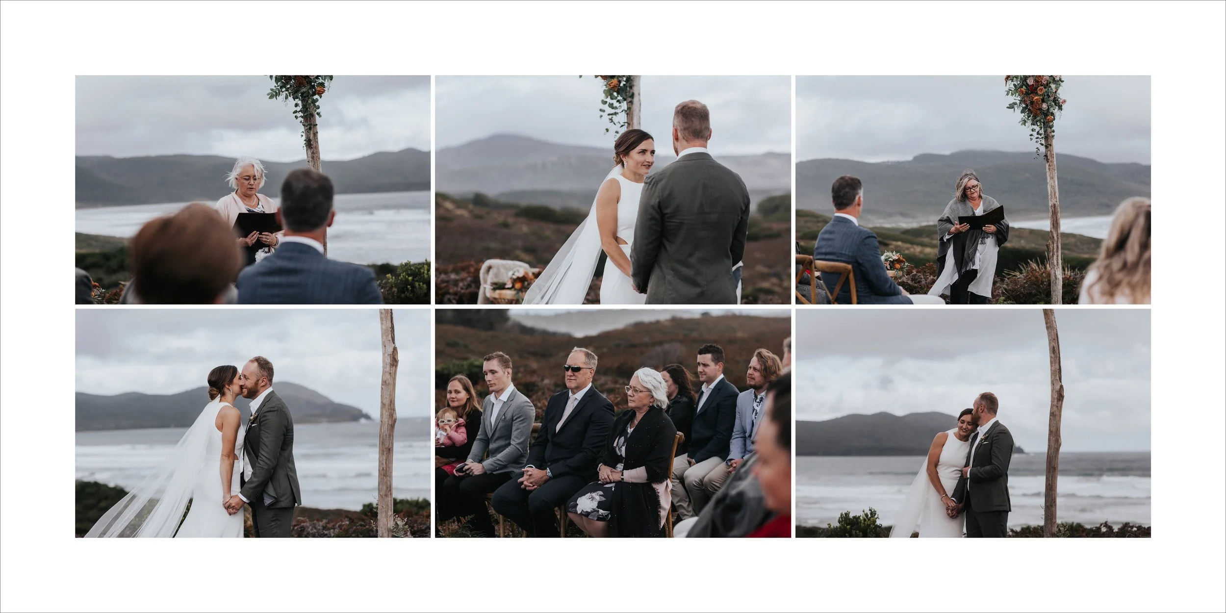 A wedding ceremony taking place outdoors near the ocean with mountains in the background. The bride and groom exchange vows and kiss, while the officiant and guests look on.