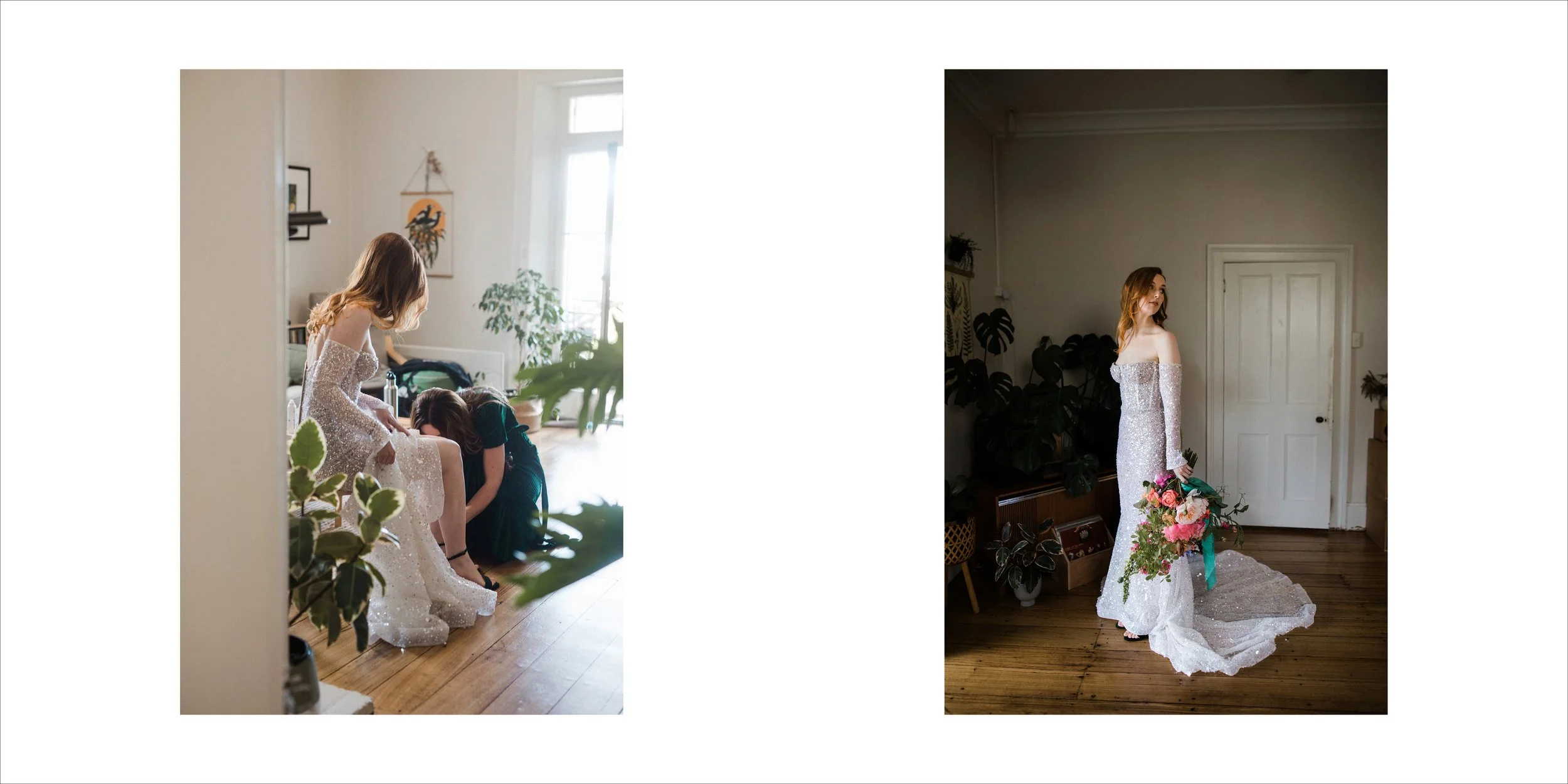 A bride in a sparkly wedding dress holding a bouquet of pink flowers, standing in a room with wooden floors and white walls, looking to her right. Another woman is helping her with the dress in a bright, sunlit room.