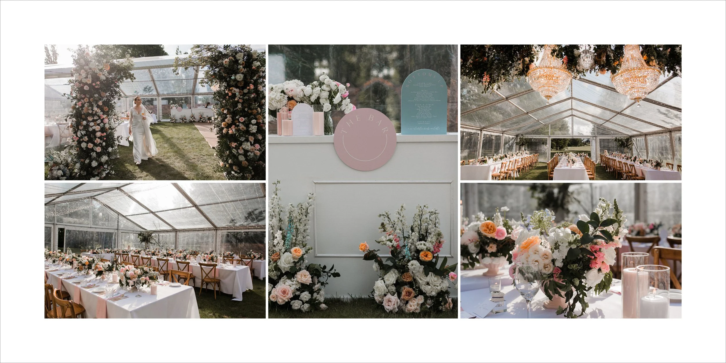Decorated wedding reception and ceremony set up in a glass tent with floral arrangements, chandeliers, and a pastel pink and blue breadboard display.