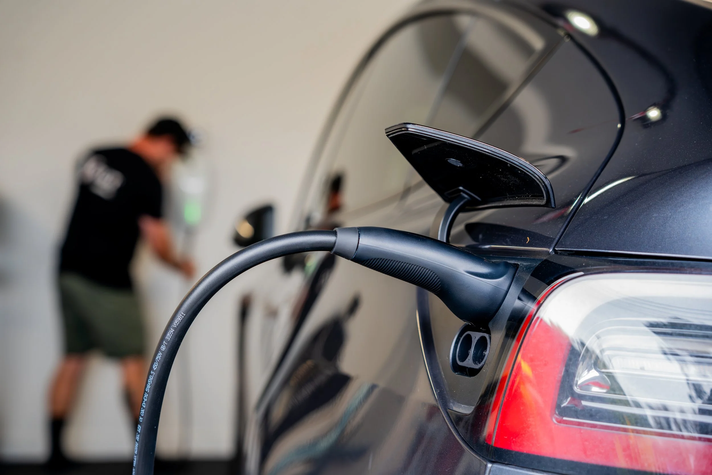 Volt Solutions electrician installing a Tesla EV charger in a high-end home in Auckland, North Shore.