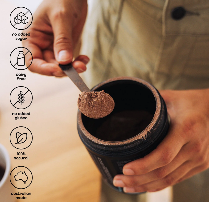 Mans hand scooping out a brown powder from a canister