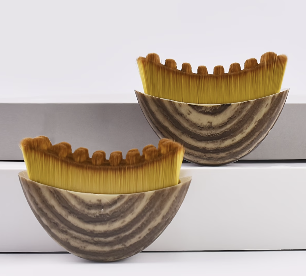 2 concave shaped brushes used to stimulate facial lymphatics
