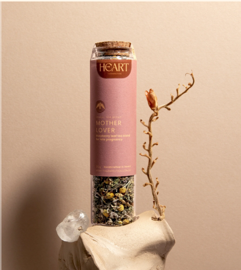 Tall glass jar with a cork stopper and a pink label filled with Mother Lover- pregnancy support tea - 30g