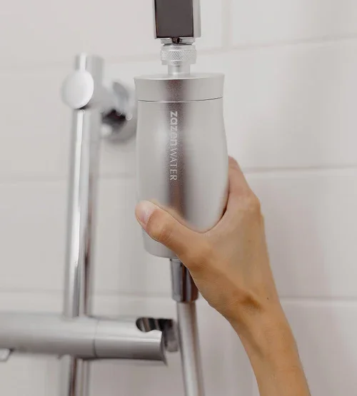 Zazen shower filter being attached to a shower head