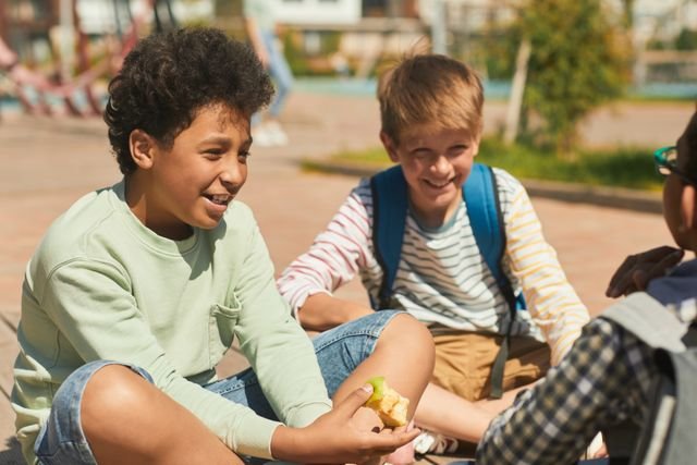 Kids on the playground in a circle talking